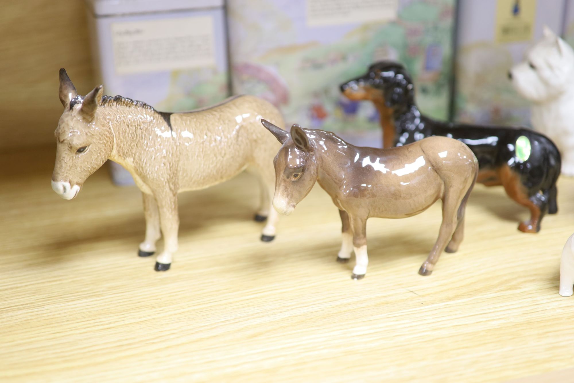 Three Beswick donkeys and four dogs, and four Tales of Honeysuckle Hill figures, tallest 13cm